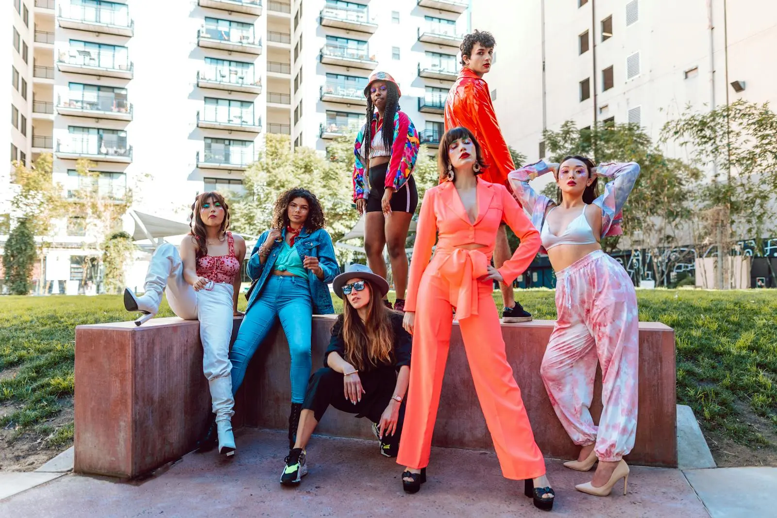 A fashion-forward diverse group showcasing vibrant street style in a city backdrop.